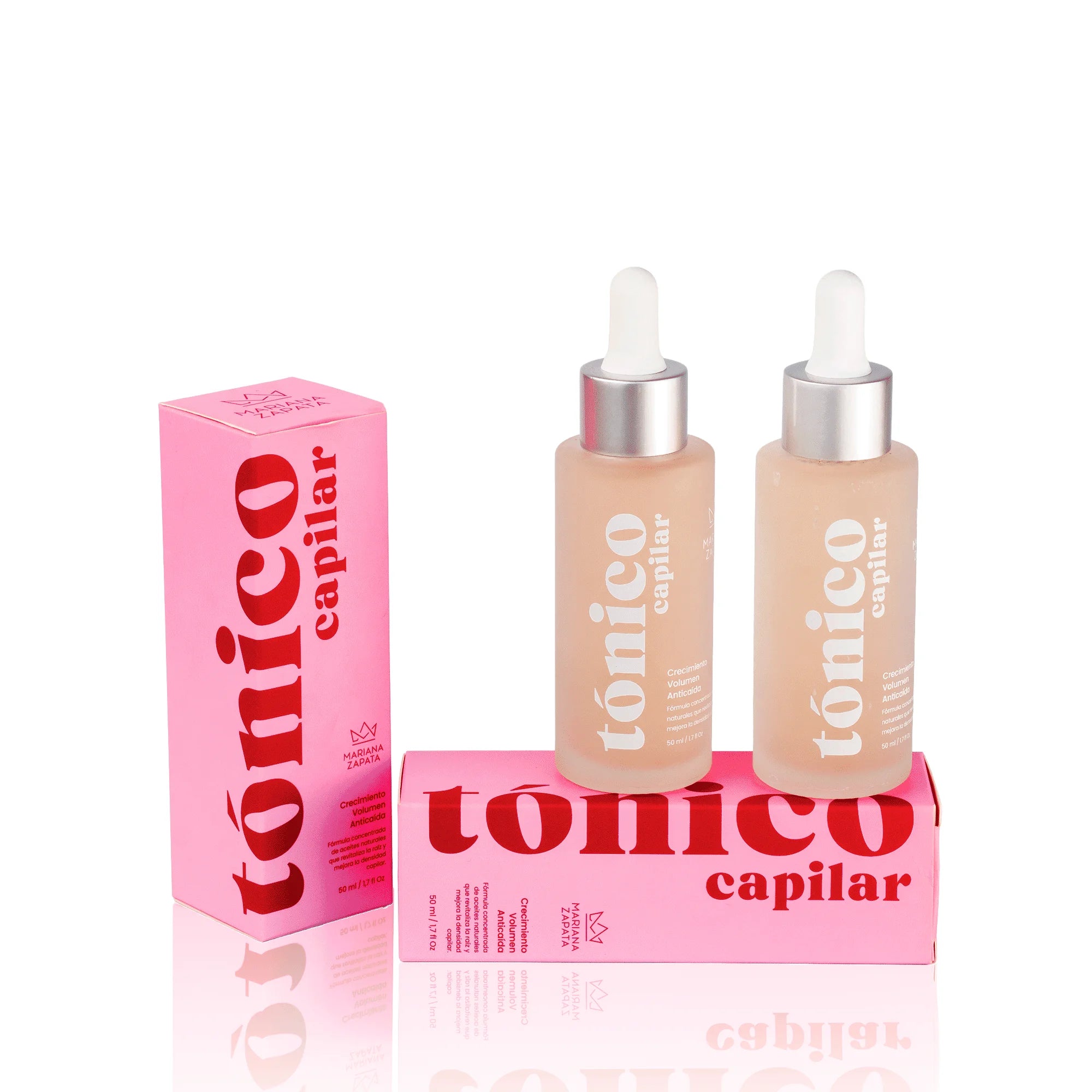 Kit DUO Tónicos Capilares, cajas y botellas sobre fondo rosa – By Mariana Zapata